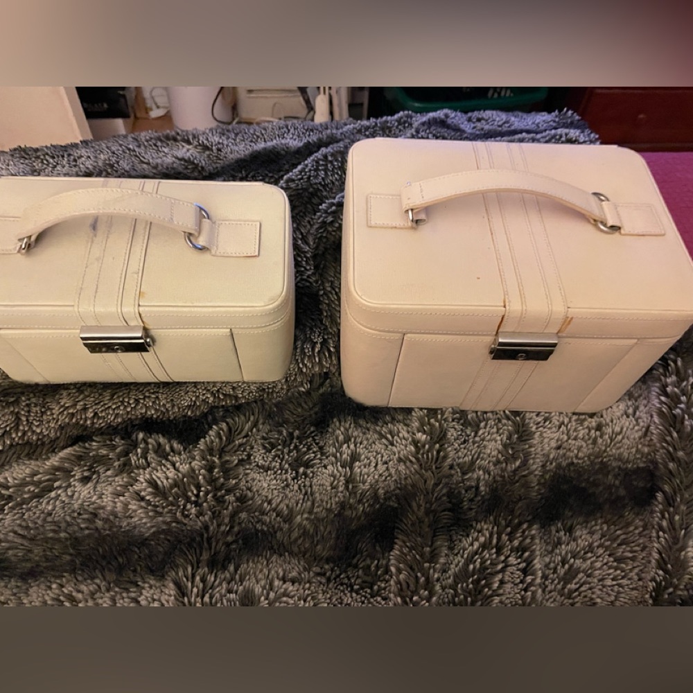 A set of two Pottery Barn cream leather jewelry boxes.